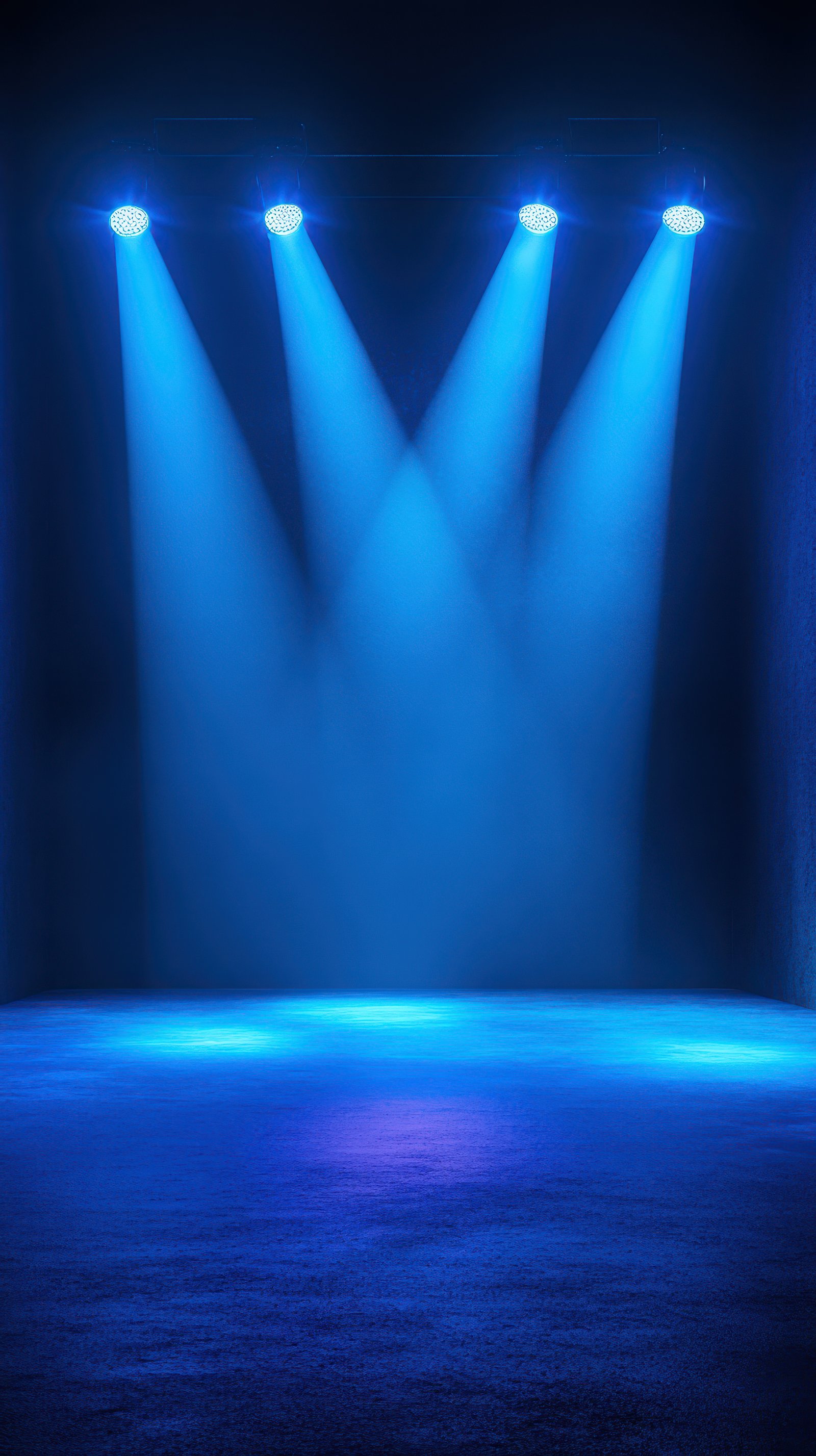 Spotlights shine down on an empty stage creating a vibrant atmosphere for an upcoming performance